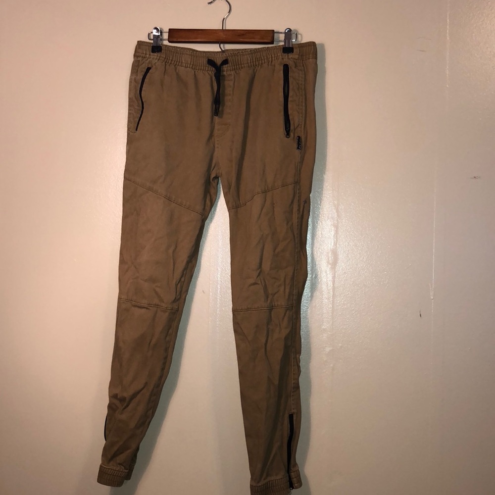khaki joggers with black zippers